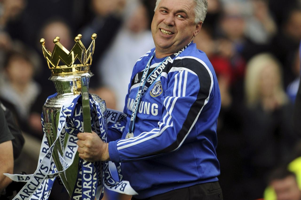 'Chelsea\'s soccer coach Carlo Ancelotti celebrates after winning the English Premier League at Stamford Bridge in London May 9, 2010. Chelsea defeated Wigan Athletic 8-0 in the last match of the seas