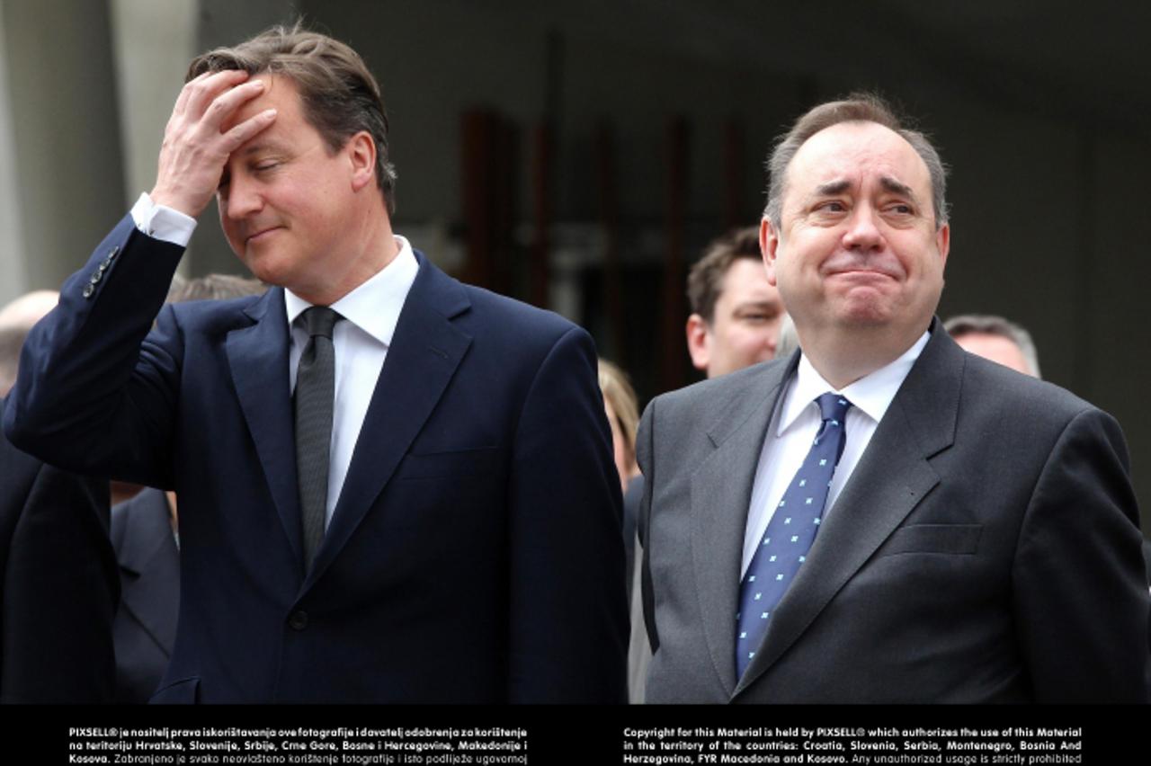 'Prime Minister David Cameron (left) and First Minister Alex Salmond (right) during the march past of 2,000 serving personnel, veterans and cadets as they march down the Royal Mile from the Castle Esp