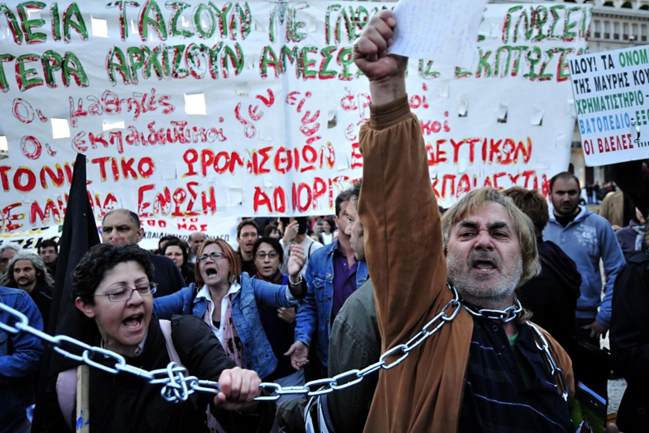 'Demonstrators shout slogans against government\'s austerity measures during a protest outside the Greek Parliament in Athens on April 27, 2010. Greece\'s central bank warned the country\'s wilting ec