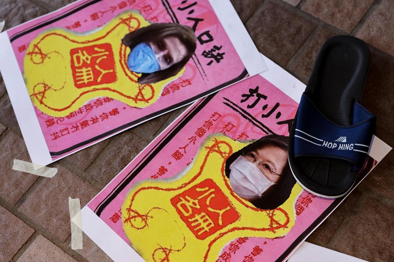 A shoe is placed next to images of U.S. House of Representatives Speaker Pelosi and Taiwan President Ing-wen, during a protest, in Hong Kong