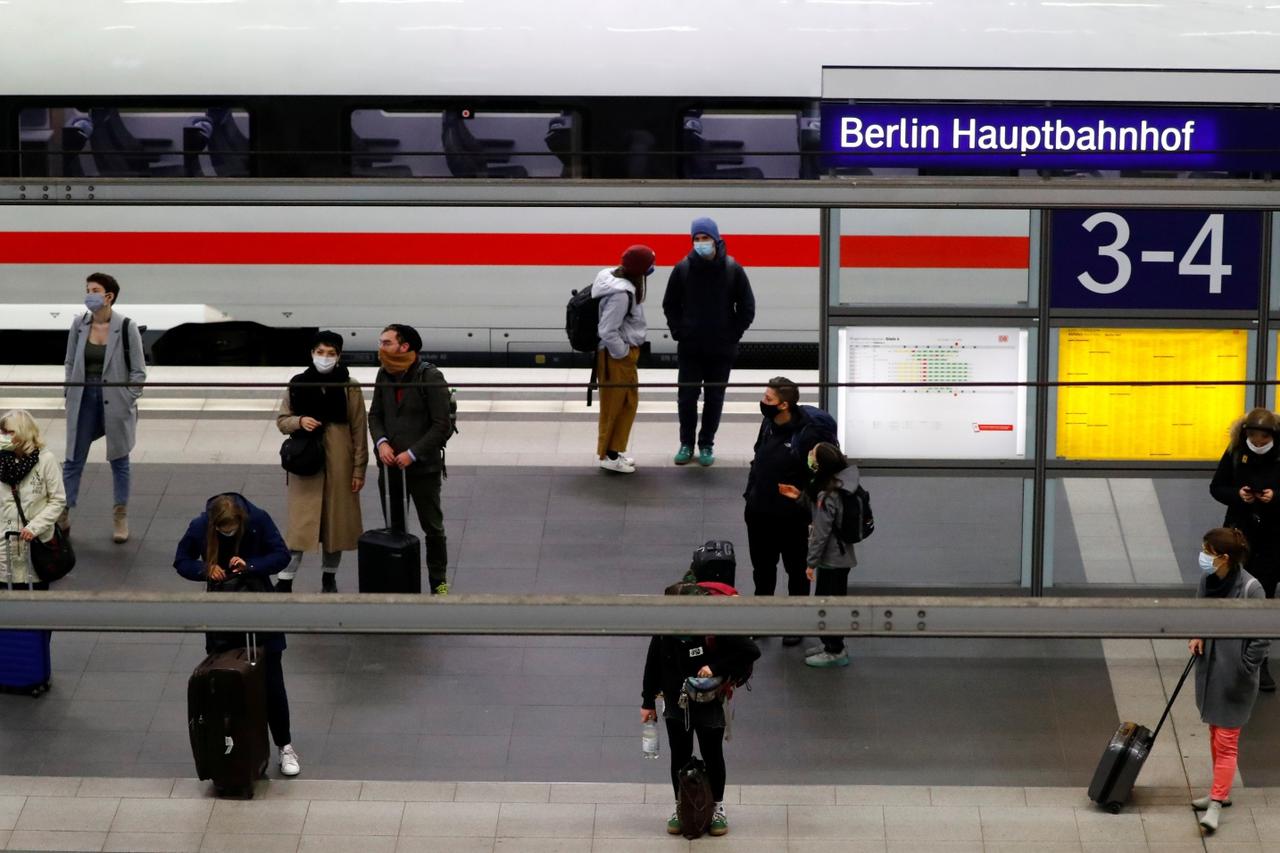 Commuters wear face masks as they wait on a platform of the main train station Hauptbahnhof, as the spread of the coronavirus disease (COVID-19) continues, in Berlin
