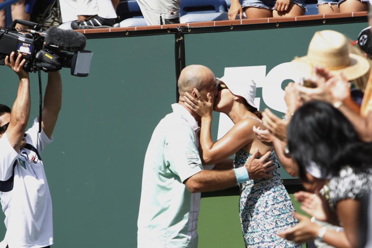 'Ivan Ljubicic of Croatia kisses his wife Aida after defeating Rafael Nadal of Spain at the Indian Wells ATP tennis tournament in Indian Wells, California March 20, 2010.   REUTERS/Kevin Lamarque  (UN