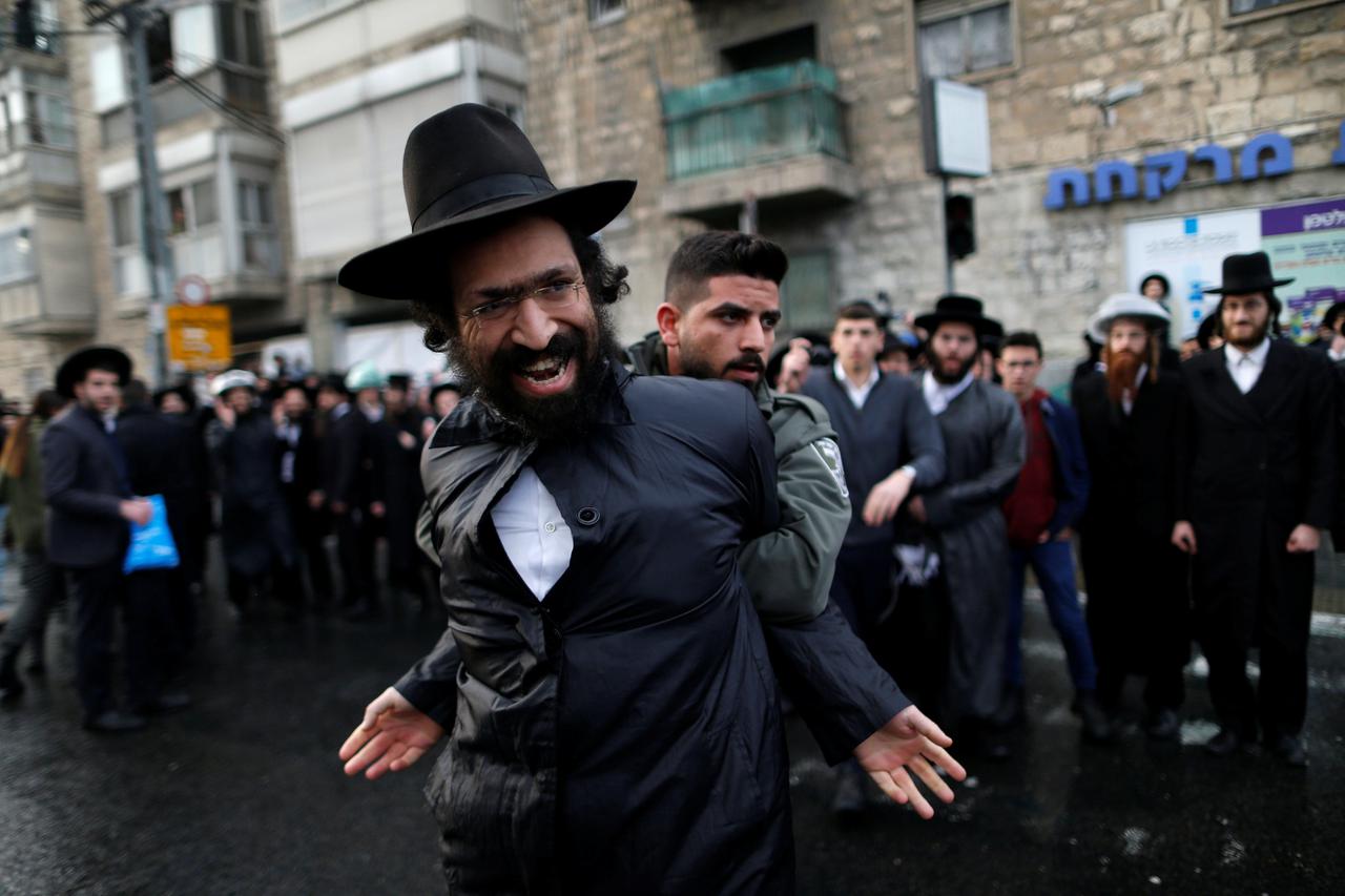 Ultra-Orthodox Jewish protestor is detained by an Israeli border policeman during a demonstration against members of their community serving in the Israeli army, part of ongoing demonstrations recently seen throughout Israel, in Jerusalem February 9, 2017