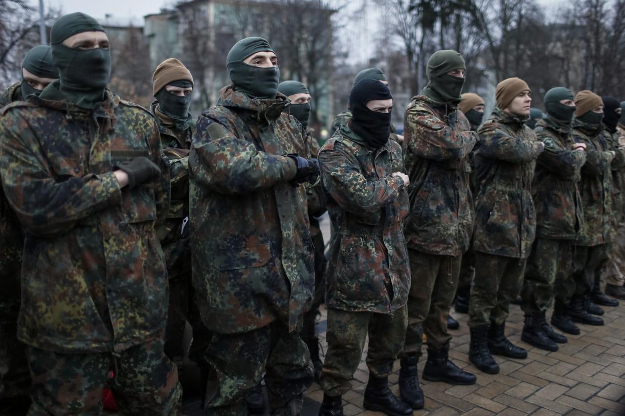 New volunteers for the Ukrainian Interior Ministry's Azov battalion line up before they depart to the frontlines in eastern Ukraine, in central Kiev January 17, 2015. Fighting raged on Saturday at the main airport of Ukraine's city of Donetsk as separatis