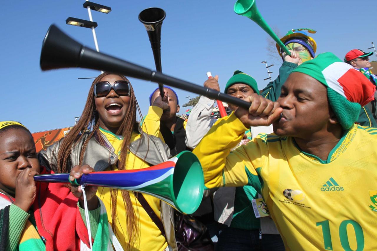 'South African supporters sing and dance while waiting for the opening ceremony of the 2010 FIFA football World Cup  on June 11, 2010 near Soccer City stadium in Soweto, suburban Johannesburg.  AFP PH