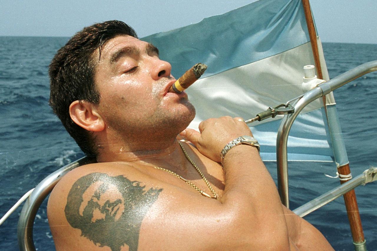 FILE PHOTO: Argentine soccer star Diego Maradona smokes a Cohiba as he rides a sailboat