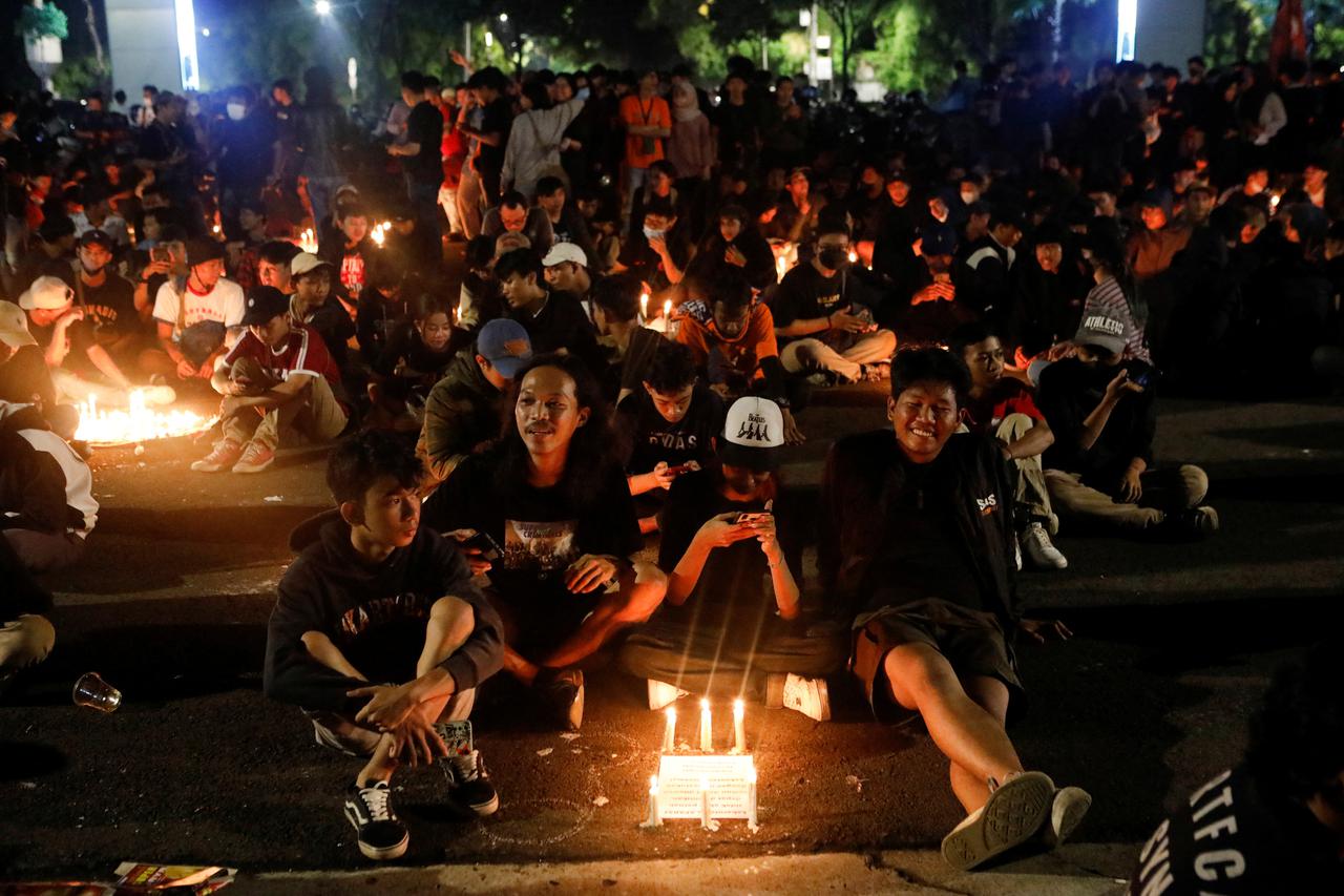 Football fans attend a vigil at Gelora Bung Karno Stadium area, following a riot after the football match between Arema vs Persebaya in Jakarta,