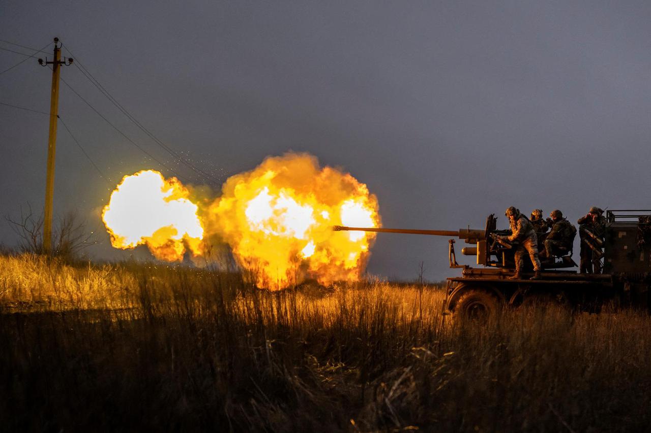 Ukrainian service members fire a S60 cannon towards Russian troops near the front-line town of Bakhmut