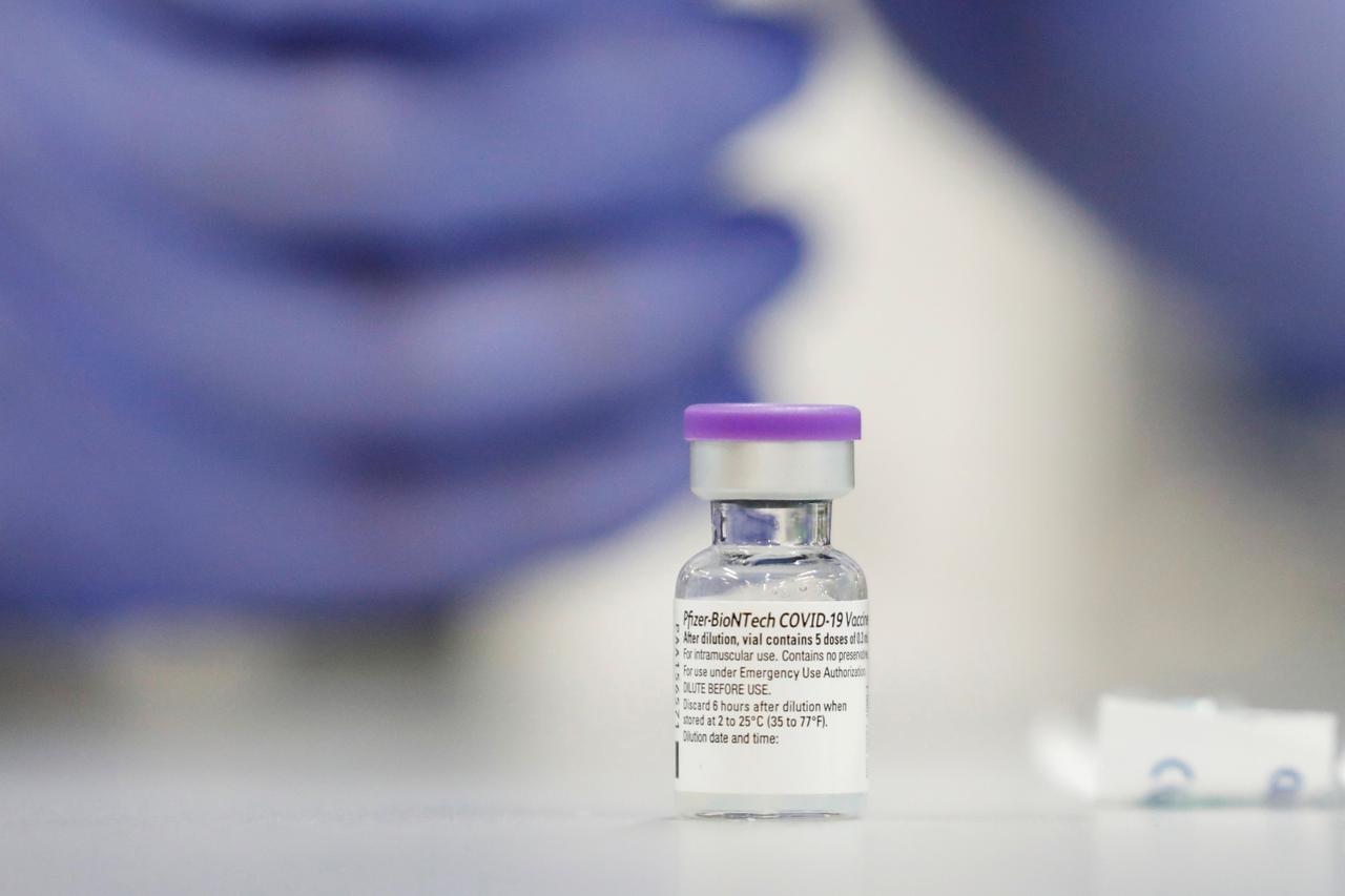 FILE PHOTO: A vial of the Pfizer vaccine against the coronavirus disease (COVID-19) is seen as medical staff are vaccinated at Sheba Medical Center in Ramat Gan, Israel