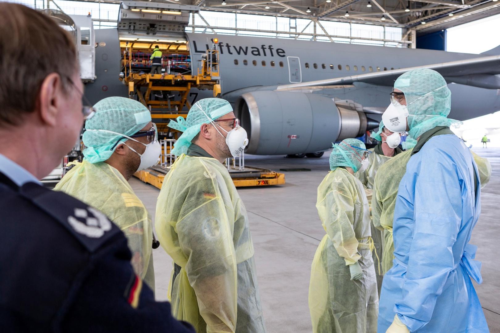 German air force Airbus A-310 "Medivac\ A Bundeswehr handout photo shows staff in protective suits leaving the German air force Airbus A-310 "Medivac" with coronavirus patients from Bergamo, after their arrival in Cologne, Germany, March 28, 2020, as the spread of the coronavirus disease (COVID-19) continues.     Luftwaffe/Kevin Schrief/Handout via Reuters ATTENTION EDITORS - THIS IMAGE HAS BEEN SUPPLIED BY A THIRD PARTY. NO RESALES. NO ARCHIVES. Luftwaffe/Kevin Schrief