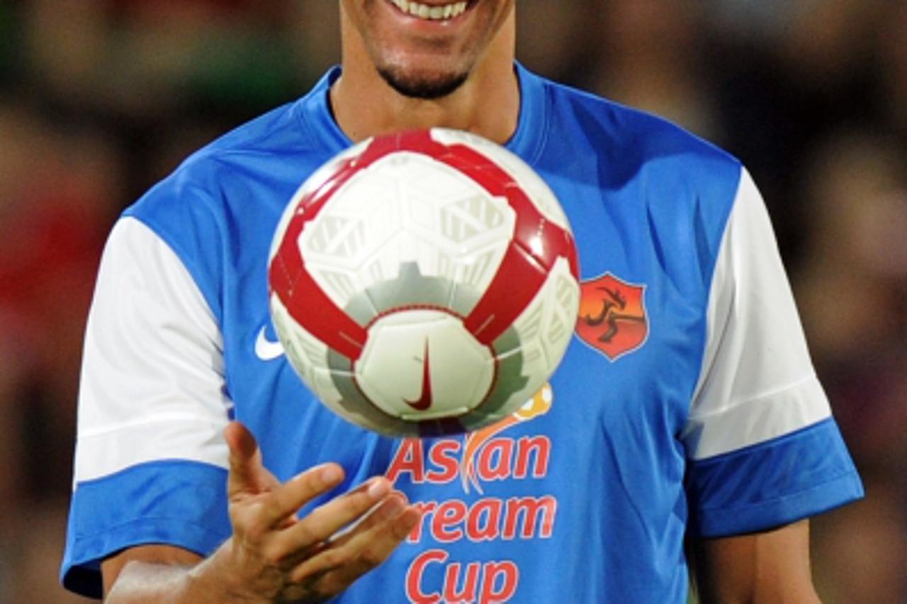 'England football veteran defender, Rio Ferdinand smiles while playing with a ball during the football charity match in the Asian Dream Cup 2012 in Bangkok on May 23, 2012.  Park Ji-Sung, the founder 
