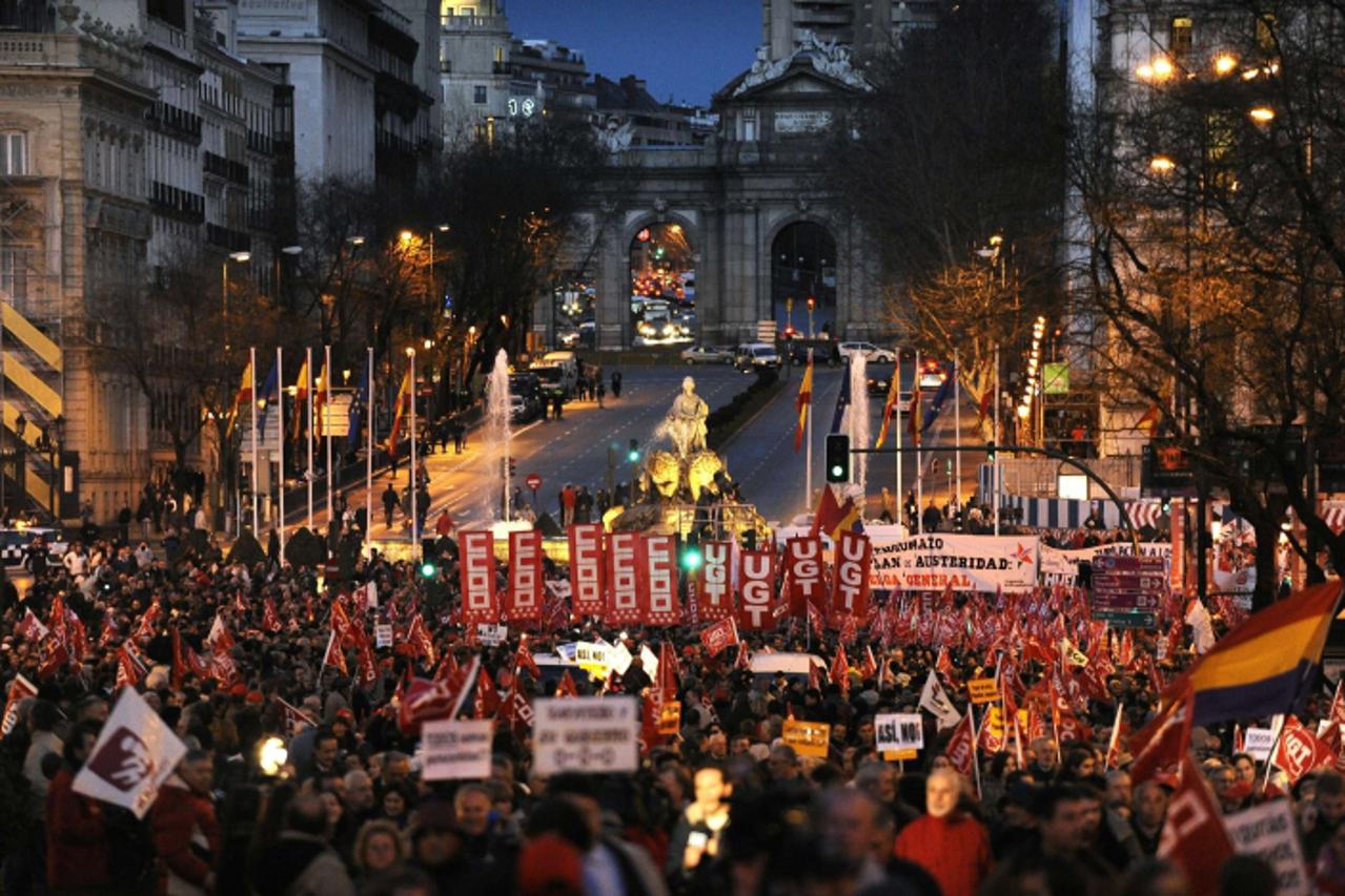 'People hold flags and banners during a demonstration called by trade unions against plans announced last month by the government of Prime Minister Jose Luis Rodriguez Zapatero to raise the legal reti
