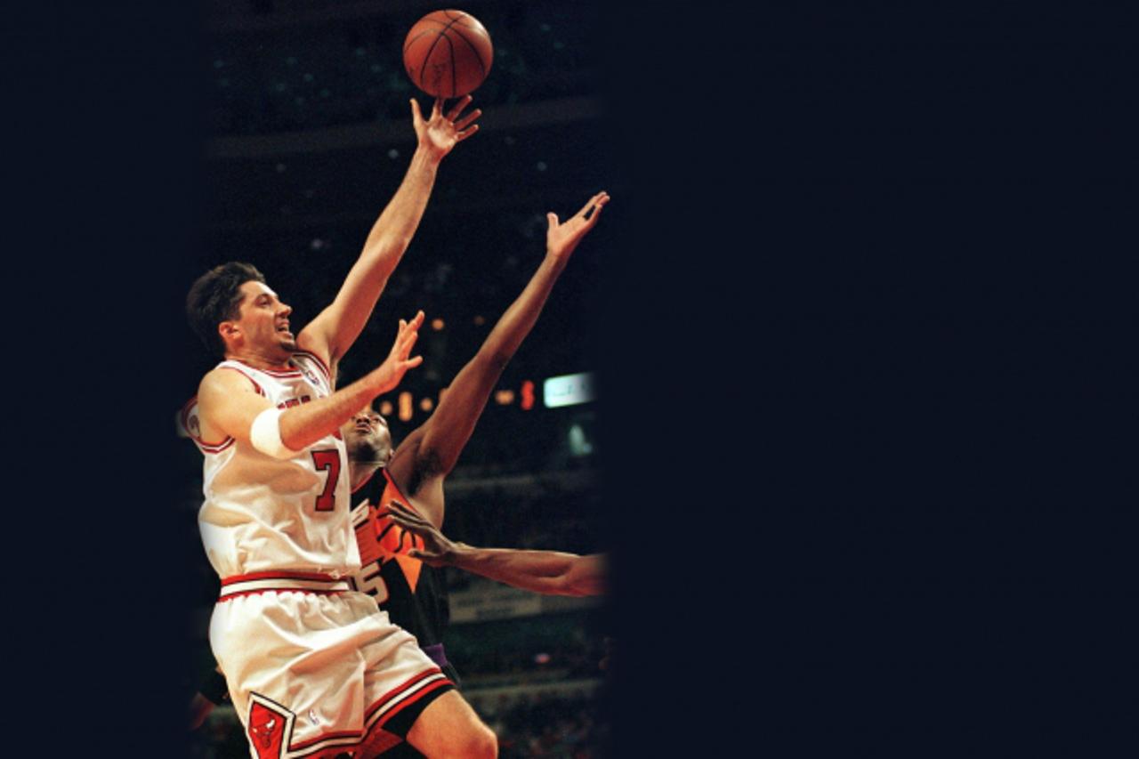 'Chicago Bulls forward Toni Kukoc (L) drives past Phoenix Suns forward Danny Manning during the fourth quarter of the 15 December game, at the United Center in Chicago, Illinois.  The Bulls defeated t