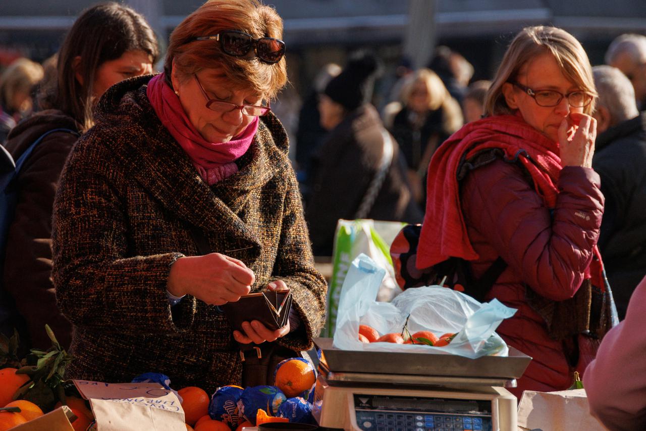A woman is seen paying for fruits at Dolac market in Zagreb