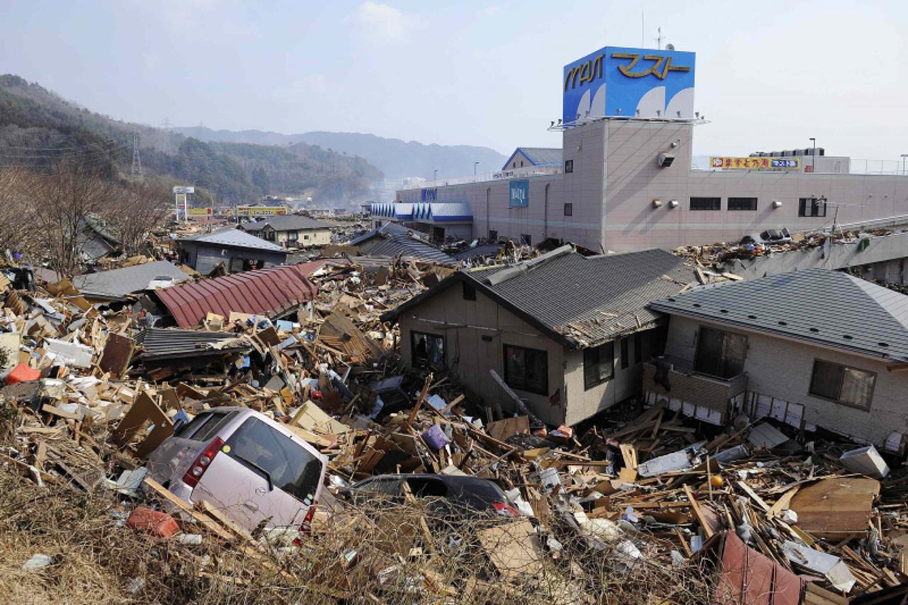 'A parking lot of a shopping center filled with houses and debris is pictured in Otsuchi town, Iwate prefecture March 13, 2011, two days after the devastating earthquake and tsunami hit the area. Pict