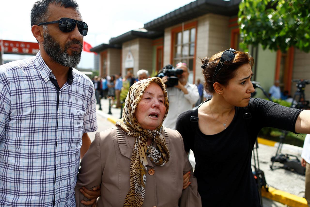 Sacide Bugda, mother of Abdulhekim Bugda who was one of the victims of  yesterday's blast at Istanbul Ataturk Airport, is comforted by her relatives as she walks to the front of a morgue in Istanbul, Turkey, June 29, 2016. REUTERS/Osman Orsal