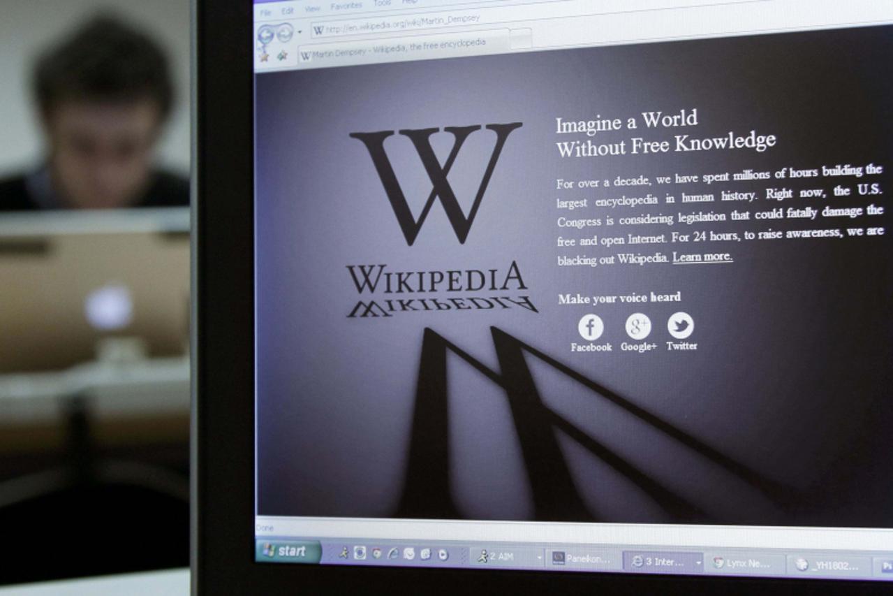 'A reporter\'s laptop shows the Wikipedia blacked out opening page in Brussels January 18, 2012. The blackout scheduled for Wednesday to protest against proposed legislation on online piracy has faile