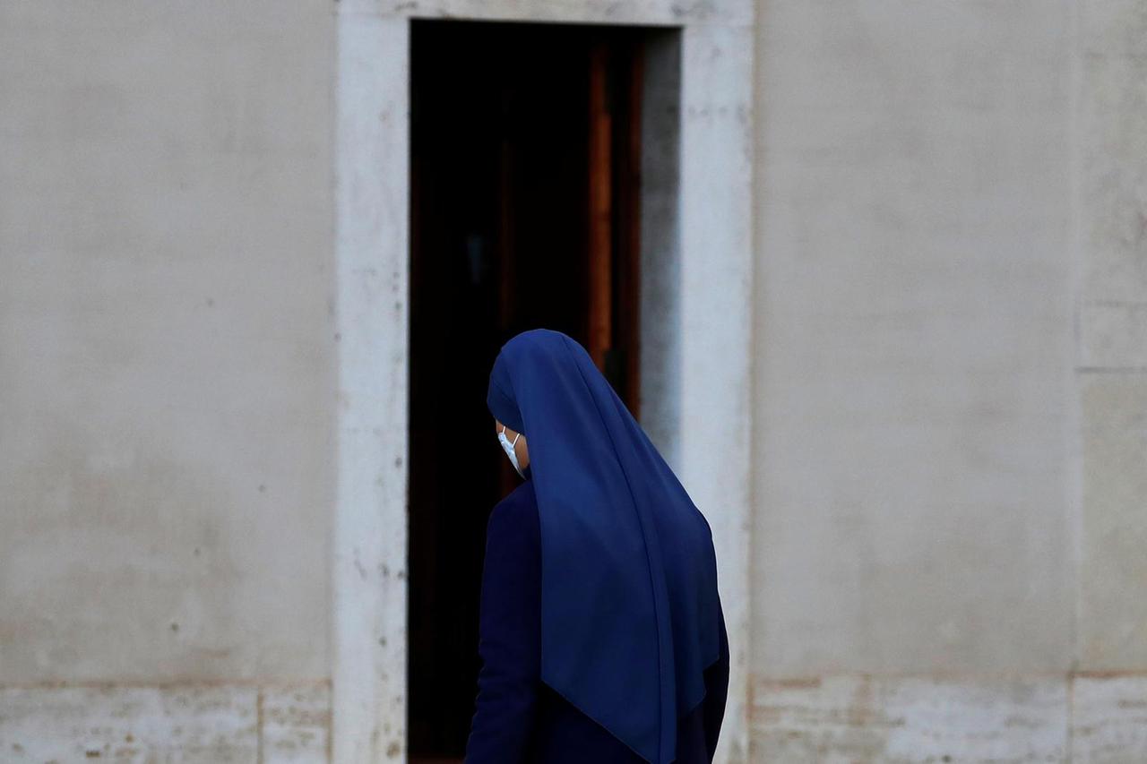 A nun walks in the San Damaso Courtyard at the Vatican