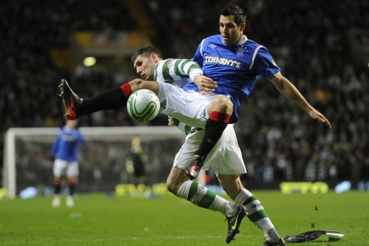 'Rangers\' Carlos Bocanegra (R) challenges Celtic\'s Gary Hooper during their Scottish Premier League \'Old Firm\' derby soccer match at Celtic Park stadium in Glasgow, Scotland, December 28, 2011. RE