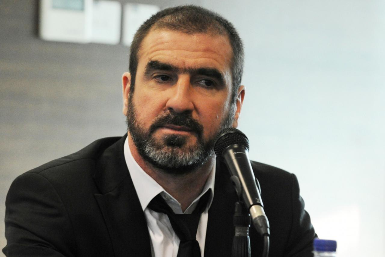 'French former footballer Eric Cantona attends a press conference during the official launch of the Courts Young Lion fan club partnership in Singapore on March 3, 2011. Retired Brazilian footballer P