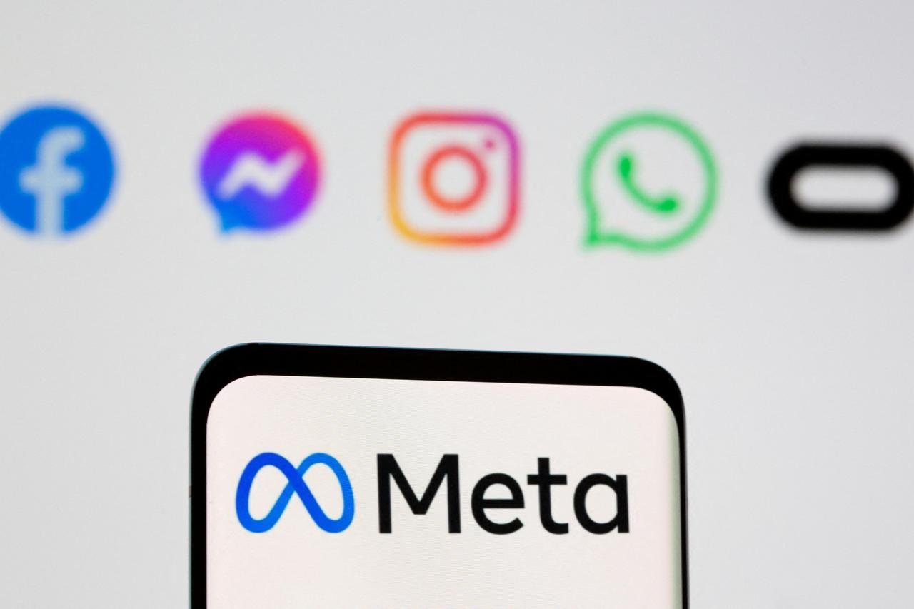 FILE PHOTO: Facebook's new rebrand logo Meta is seen on smartpone in front of displayed logo of Facebook, Messenger, Intagram, Whatsapp, Oculus in this illustration taken
