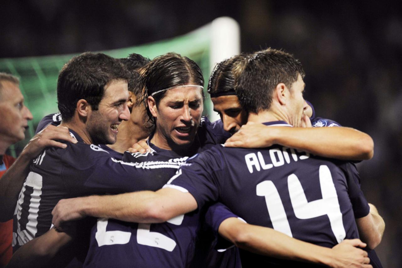 'Real Madrid\'s players celebrate after Real Madrid\'s Argentinian midfielder Angel Di Maria scores a goal during the UEFA Champions League football match Auxerre vs Real Madrid, on September 28, 2010