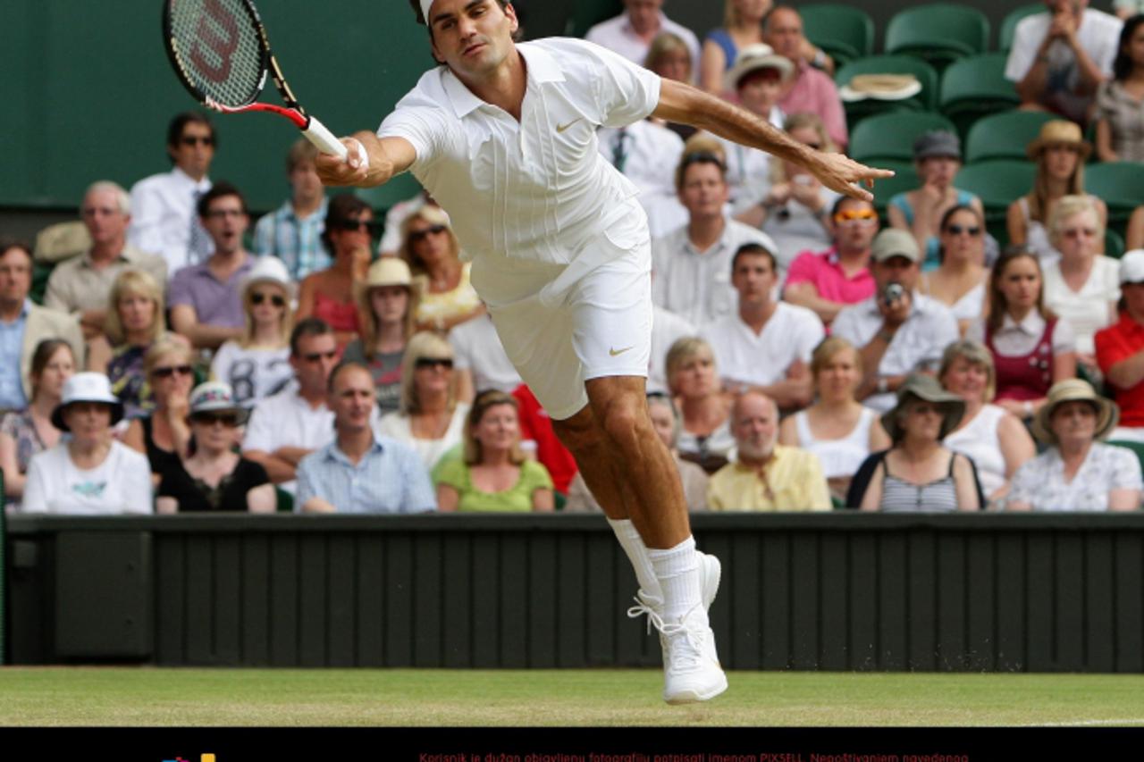 'Switzerland\'s Roger Federer in action against France\'s Arnaud Clement during Day Five of the 2010 Wimbledon Championships at the All England Lawn Tennis Club, Wimbledon. Photo: Press Association/Pi