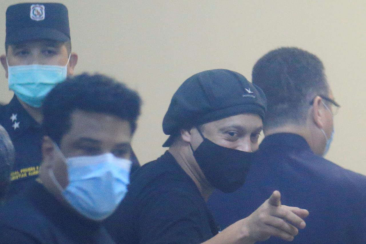 Ronaldinho is seen arriving at the hearing at the Supreme Court of Justice where he could be released from the home prison he has been holding for 4 months in a hotel in Asuncion
