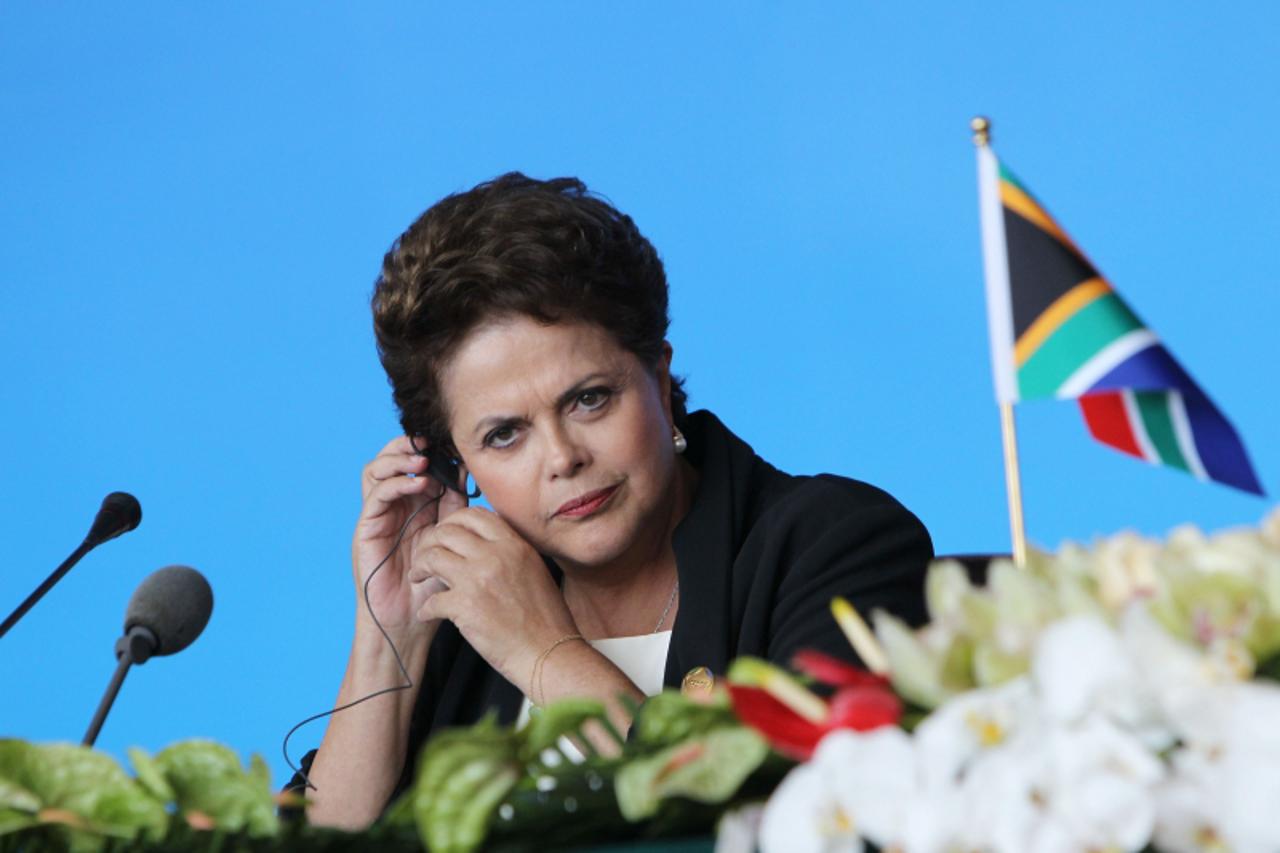 \'Brazilian President Dilma Vana Rousseff adjusts her earphones at a joint press conference during the BRICS summit in Sanya, on the southern Chinese island of Hainan on April 14, 2011. Leaders of fiv