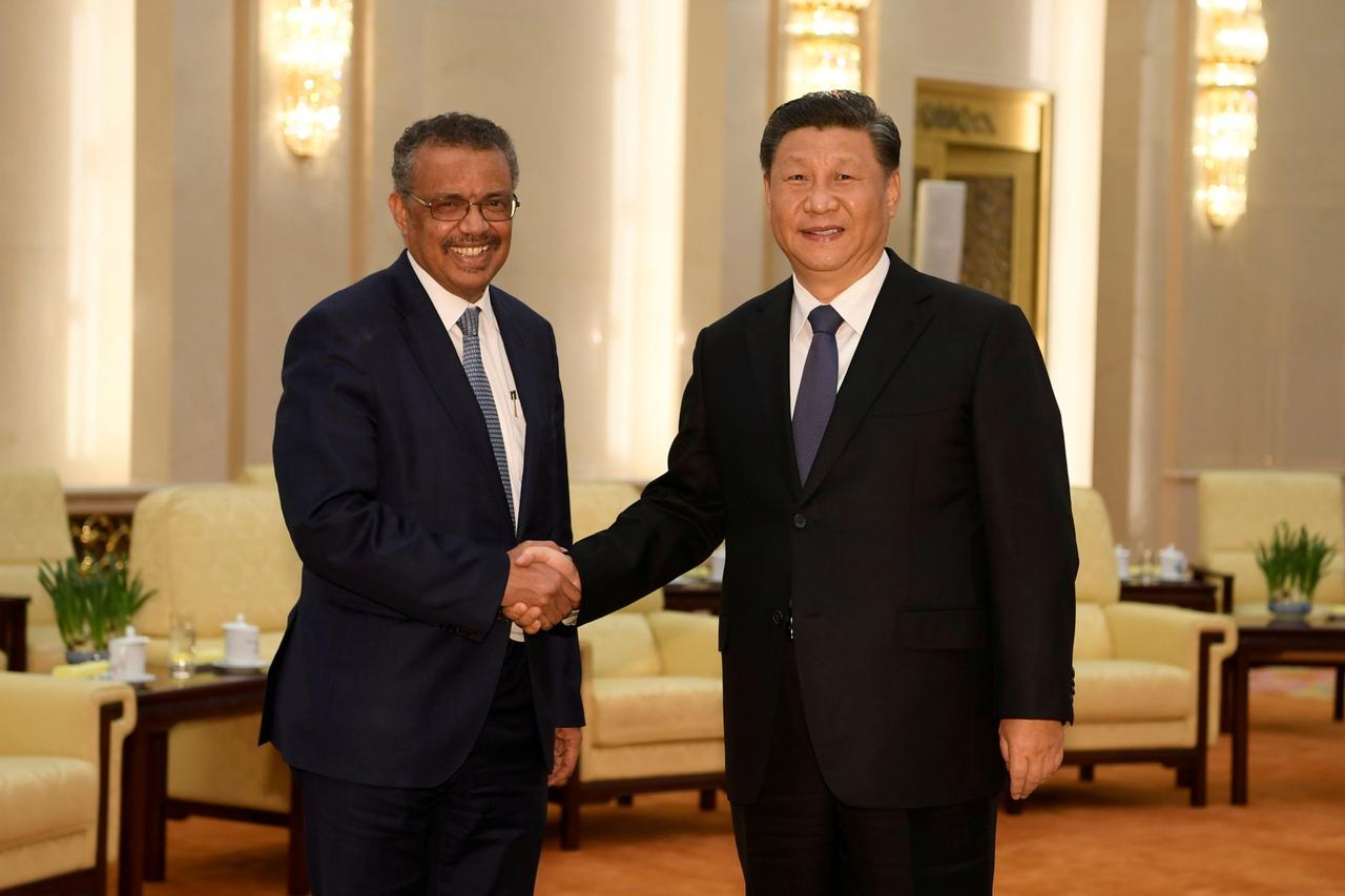 FILE PHOTO: Tedros Adhanom, director general of the World Health Organization, shakes hands with Chinese President Xi jinping before a meeting at the Great Hall of the People in Beijing