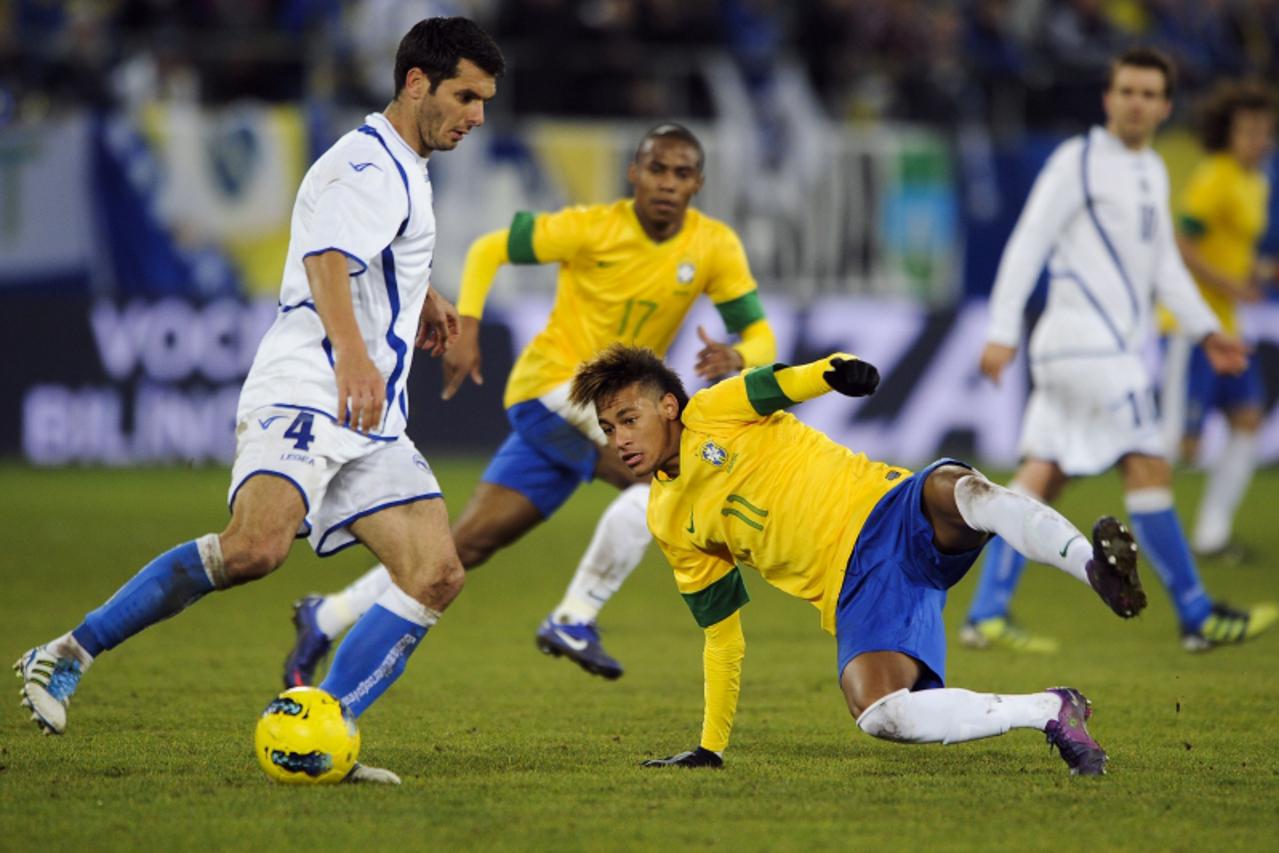 'Brazil\'s forward Neymar (C) vies with Bosnia\'s defender Sasa Papac (L) during a friendly football match between Bosnia-Herzegovina and Brazil on February 28, 2012 in St-Gallen.   AFP PHOTO / FABRIC