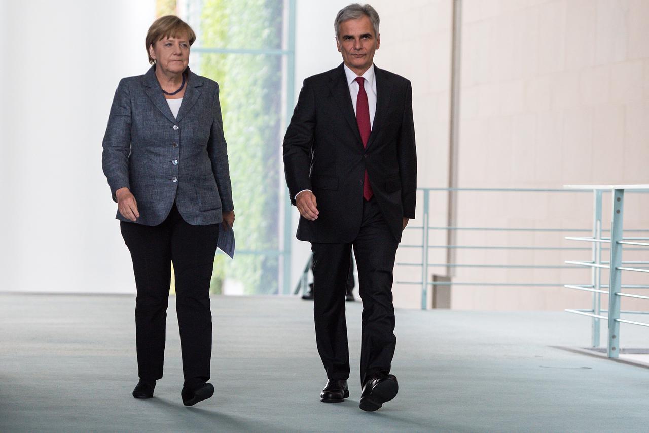 German Chancellor Angela Merkel (CDU, R) and her Austrian counterpart Werner Faymann arrive at a joint press conference on the future course of action of both countries in the ongoing refugee crisis following bilateral talks that included their economy an