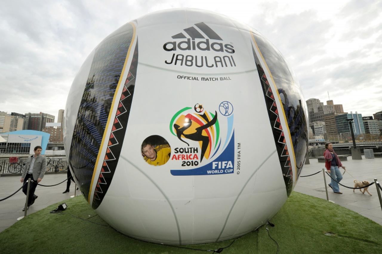 \'Competition winner Adam Santarossa looks out from a giant replica Jabulani World Cup ball, where he is spending the next 31 days watching all 64 games live from South Africa, in Melbourne on June 23