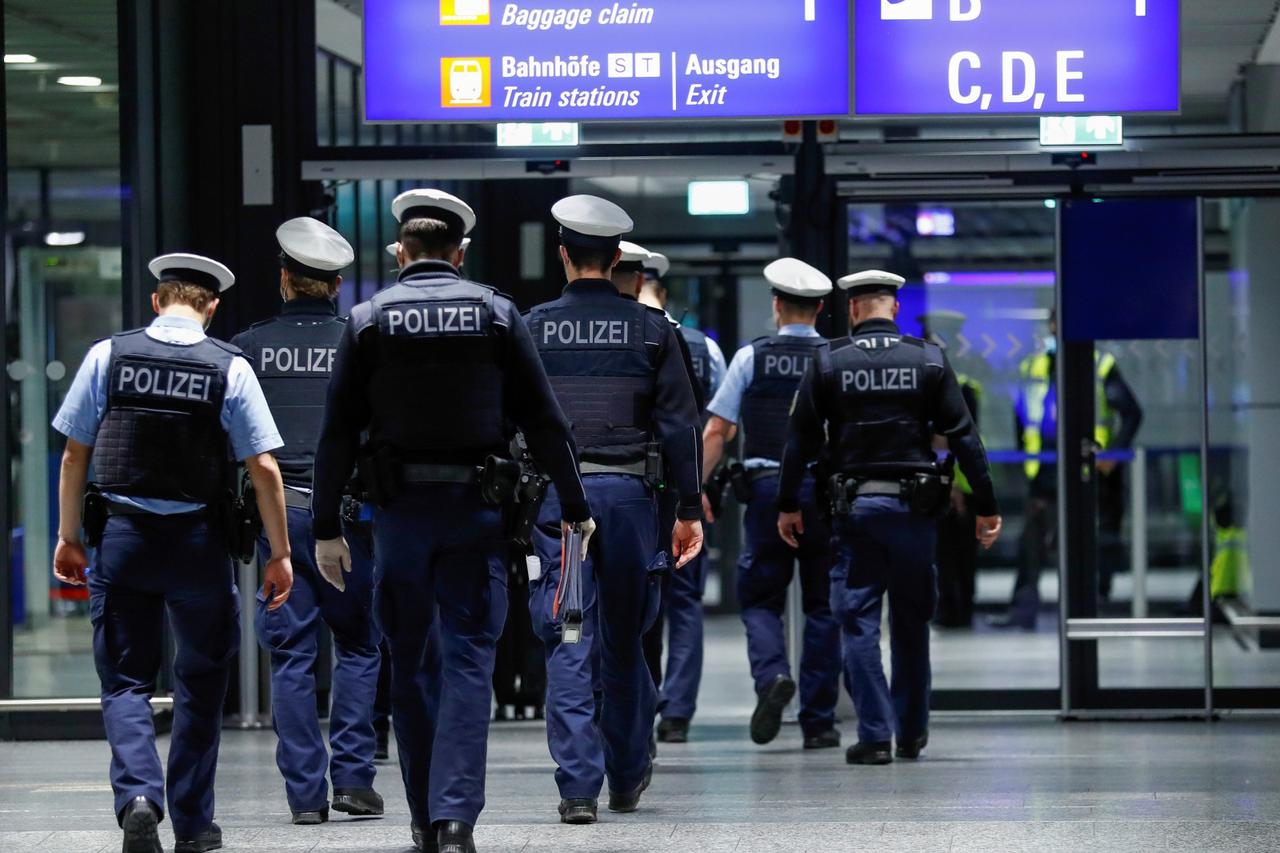 Federal police officers check flight passengers arriving from Britain at Frankfurt Airport