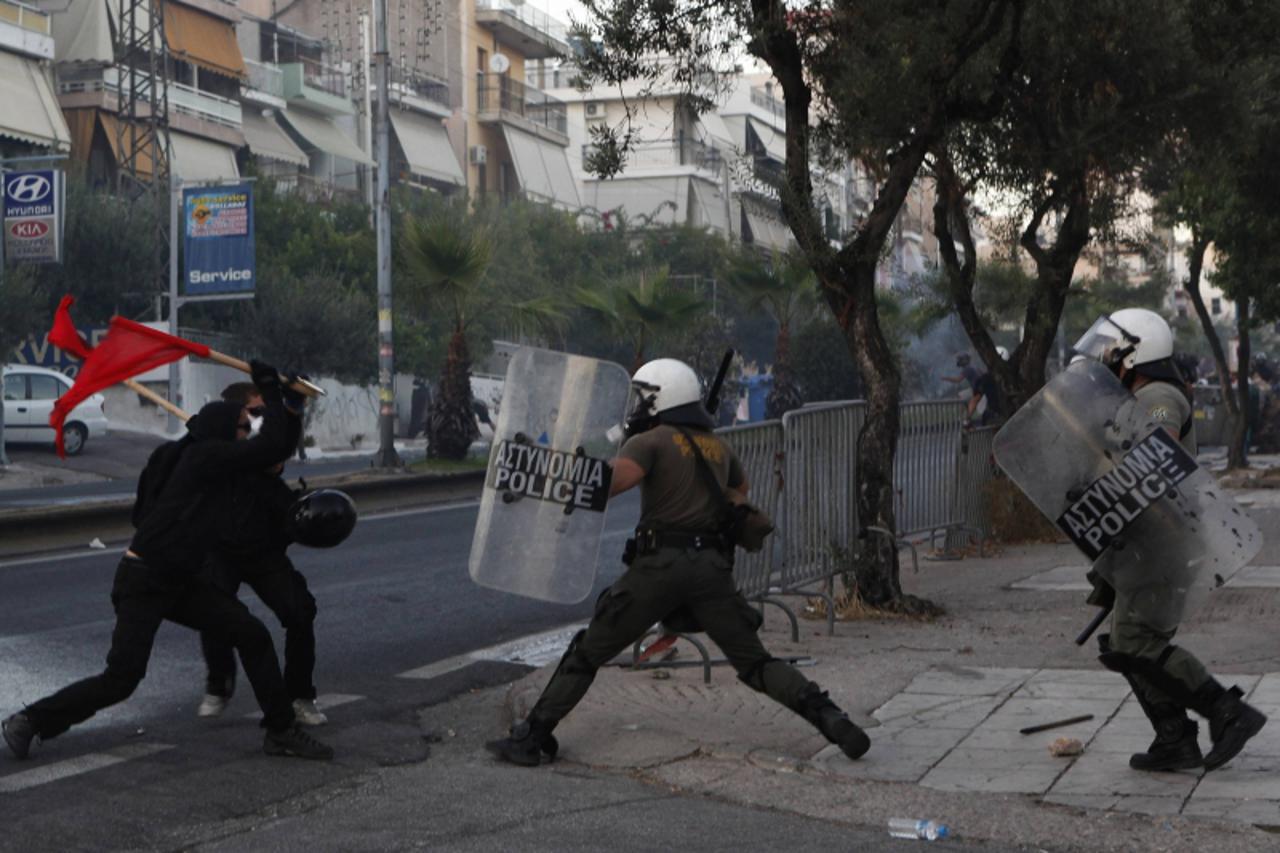 'Protesters clash with riot police during a rally, following the death of a 35-year-old anti-racism rapper, at Keratsini suburb southwest of Athens September 18, 2013. Greek police searched the Athens