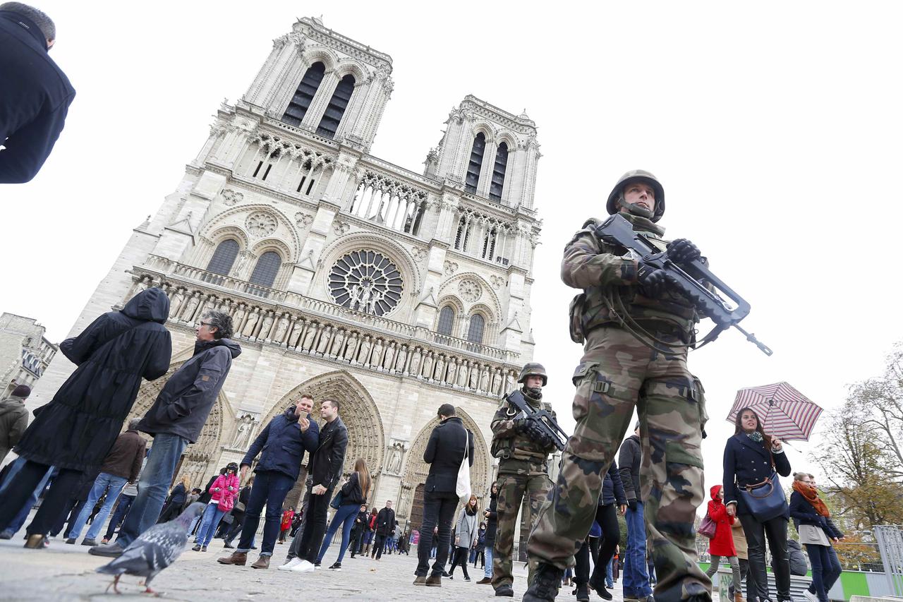 French military patrol near the Notre Dame Cathedral the day after a series of deadly attacks in Paris, France, November 14, 2015.  