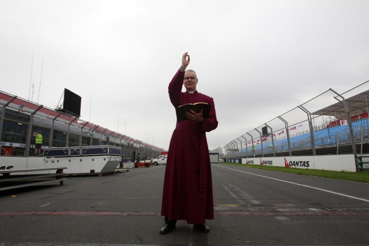 'Anglican Archbishop of Melbourne Dr Philip Freier blesses the track ahead of the Australian Formula One Grand Prix in Melbourne in this picture taken March 12, 2011. Embattled organisers of Australia