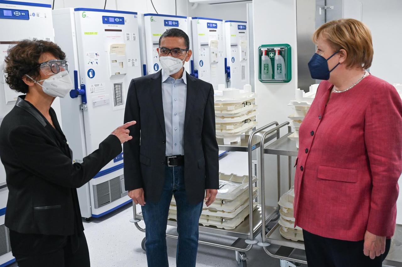 Ozlem Tureci and Ugur Sahin, CEOs and founders of BioNTech and German Chancellor Angela Merkel visit the BioNTech COVID-19 mRNA vaccine production facility in Marburg