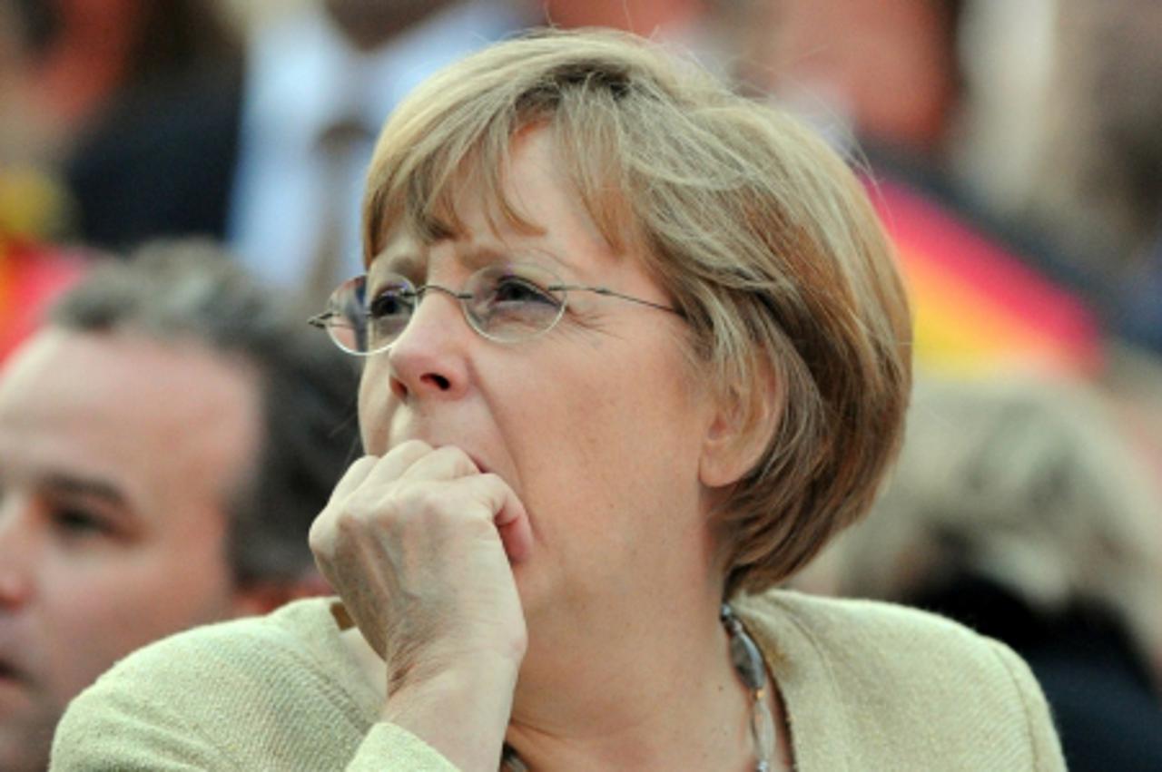 'German Chancellor Angela Merkel reacts on June 13, 2012 in Berlin as she watches the Euro 2012 championships football match Netherlands vs Germany played in Kharkiv, Ukraine. Germany won 2-1.   AFP P