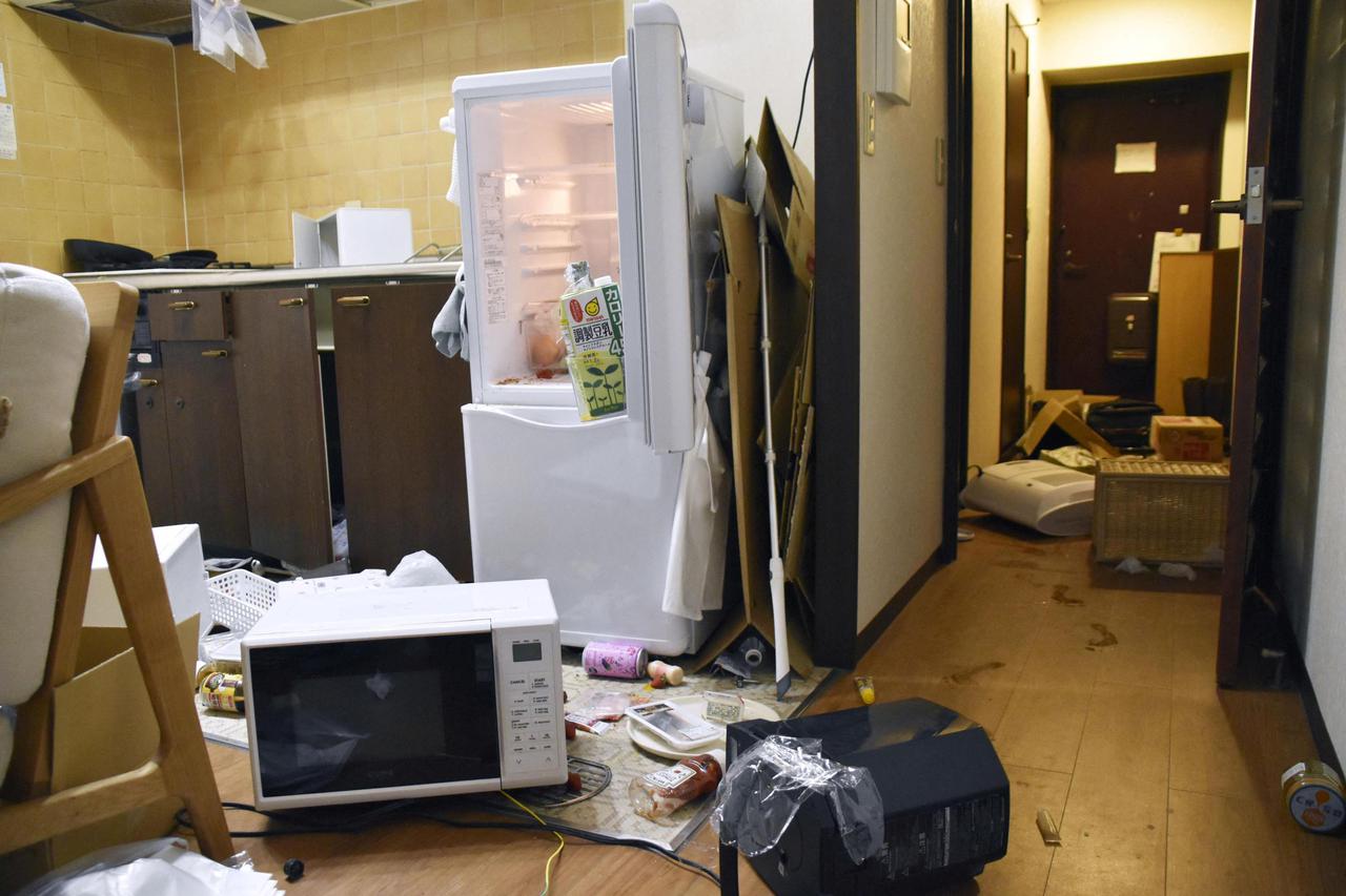 Furniture and electrical appliance are scattered caused by an earthquake at an apartment in Fukushima