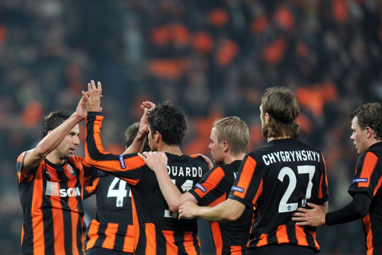 \'Players of  FC Shakhtar react after scoring against Arsenal  FC  during  UEFA Champions League, Group H football  match in Donetsk on November 3, 2010. Shakhtar won 2:1. AFP PHOTO/ SERGEI SUPINSKY 
