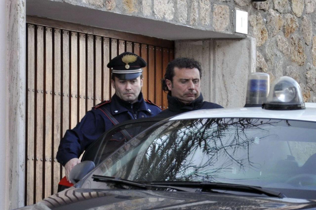 \'Costa Concordia cruise liner captain Francesco Schettino (R) is escorted by a Carabinieri in Grosseto January 14, 2012. Schettino, the captain of the Italian cruise liner that ran aground off Italy\