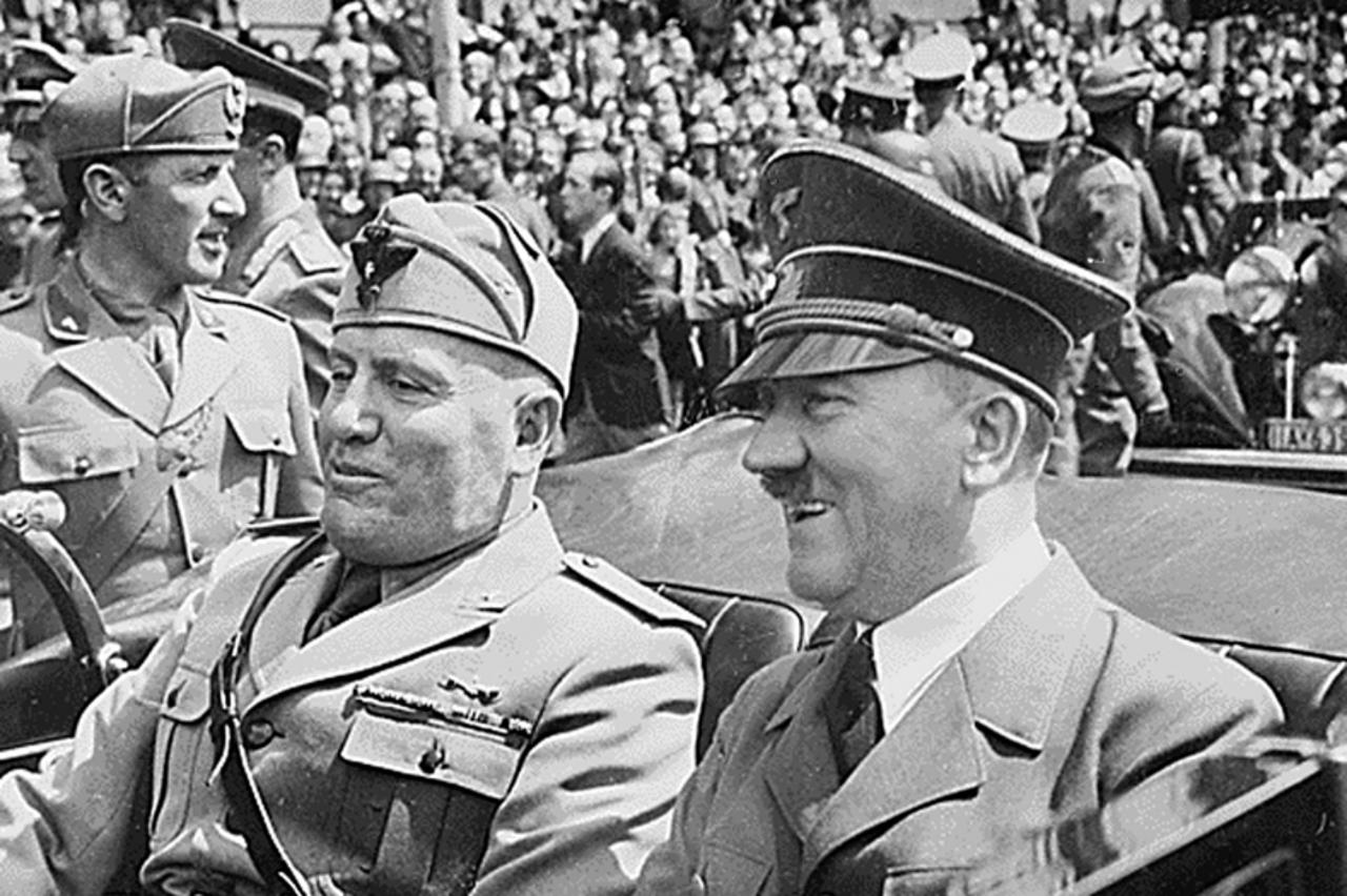 \'This file photo taken in June 1940, in Munich, Germany, shows Adolf Hitler (R) riding in a car with Italian Fascist dictator , Benito Mussolini (L) during World War II. AFP PHOTO/HO\'