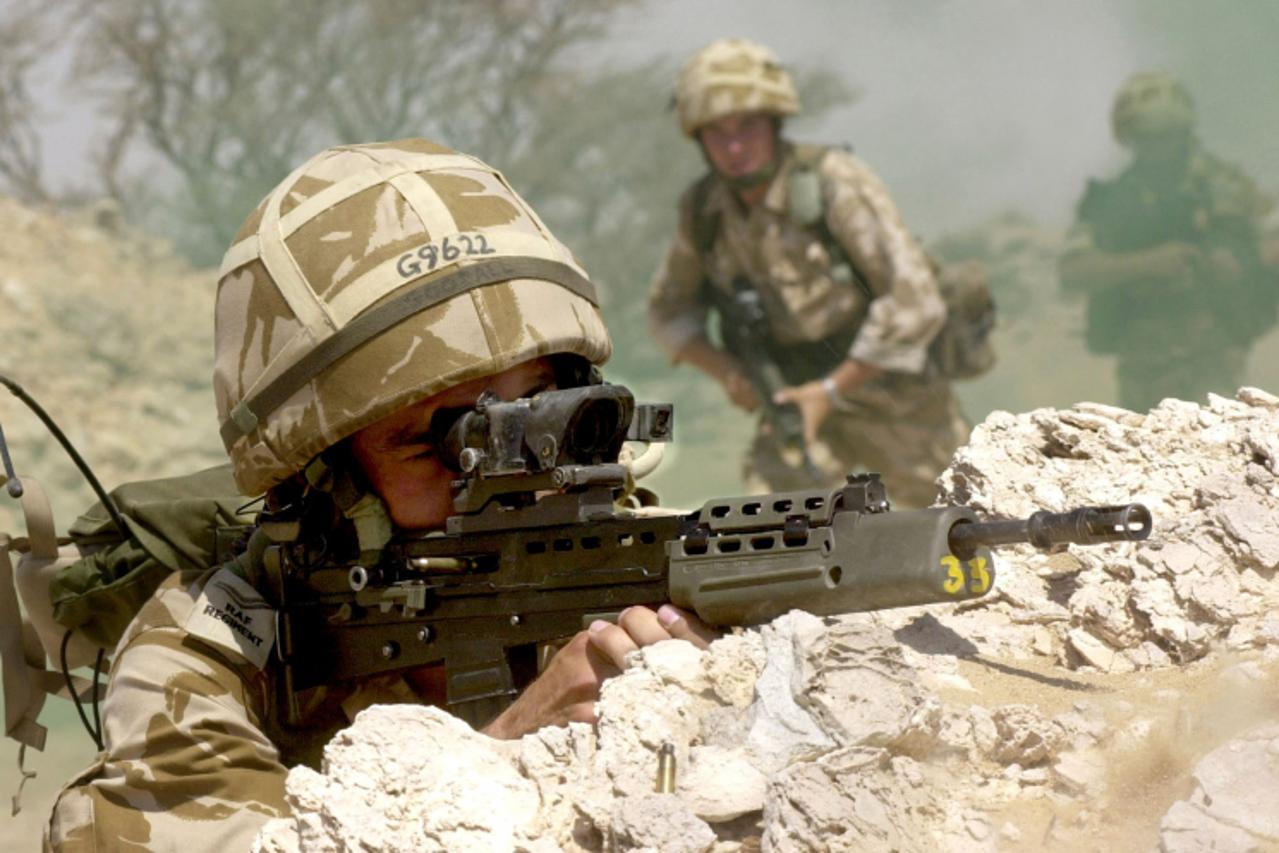 \'Cpt. Andy Goodal, 29, from Scarbourough, UK, aims his gun in section attack drills, on the ranges close to South Camp in Oman, 27 September 2001. The Regiment is part of Exercise Saif Sareea II or S