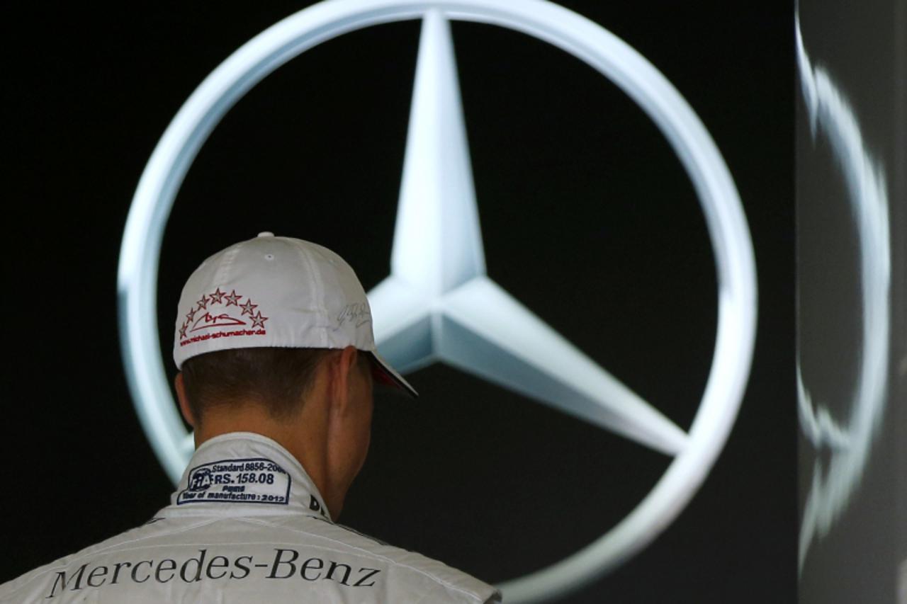 'Mercedes Formula One driver Michael Schumacher of Germany walks in his garage at the Suzuka circuit October 4, 2012, ahead of Sunday\'s Japanese F1 Grand Prix. Seven-times world Formula One champion 