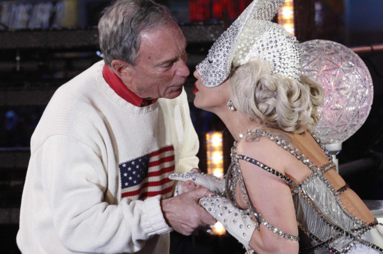 'Singer Lady Gaga and New York City Mayor Michael Bloomberg kiss each other during celebrations in the New Year Eve ball in Times Square in New York, January 1, 2012. REUTERS/Eduardo Munoz (UNITED STA