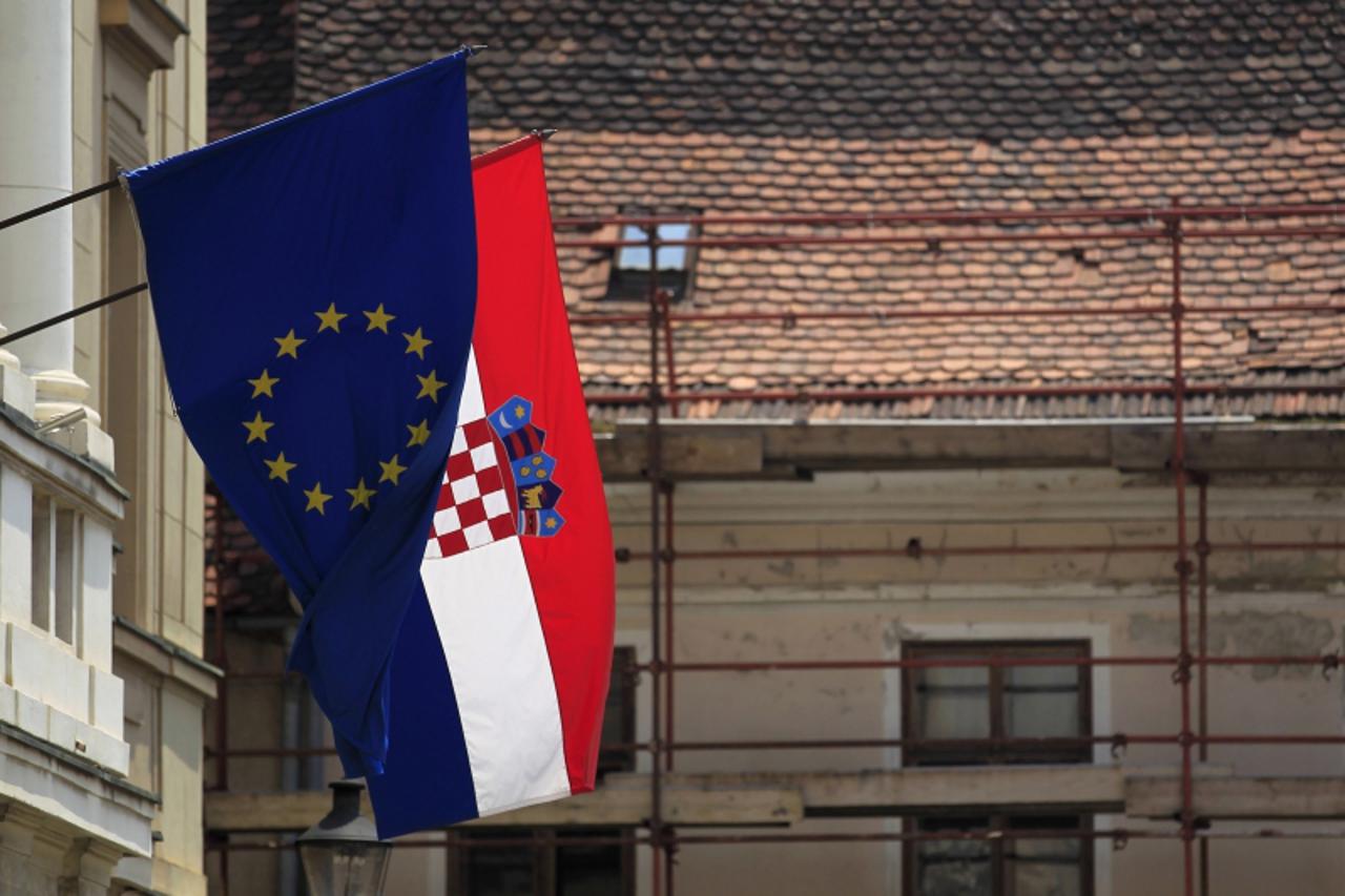 'The European Union and Croatian flags wave in the wind at Zagreb's downtown June 19, 2013. On July 1st Croatia will become the 28th member of the EU. Picture taken June 19, 2013. REUTERS/Antonio Bro