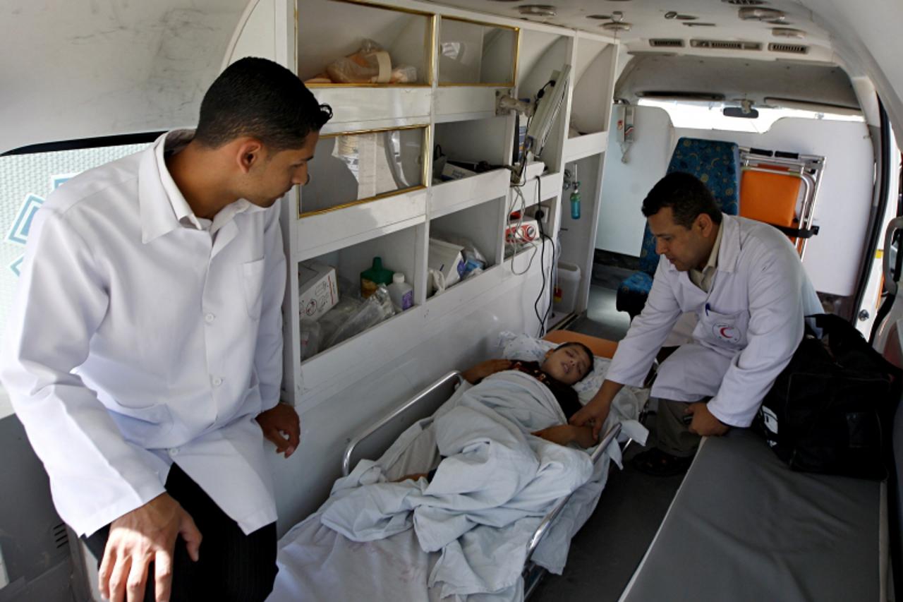 'A sick Palestinian boy arrives in an ambulance to cross into Egypt through the Rafah border crossing in the southern Gaza Strip on May 28, 2011 as Egypt reopened the border, allowing people to cross 