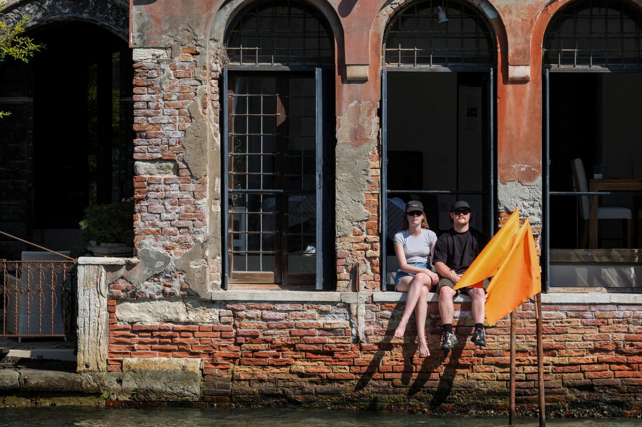 Tourists battle with rising temperature as the city gears up for 'Redentore' festival celebrations in Venice