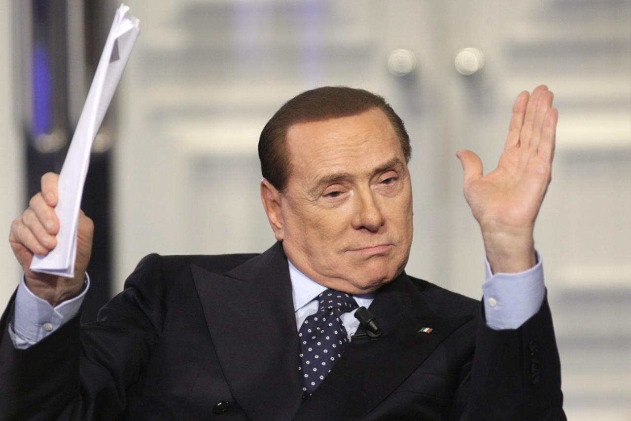 'Italy's former Prime Minister Silvio Berlusconi gestures as he appears as a guest on the RAI television show Porta a Porta (Door to Door) in Rome February 20, 2013. REUTERS/Remo Casilli (ITALY - Tag